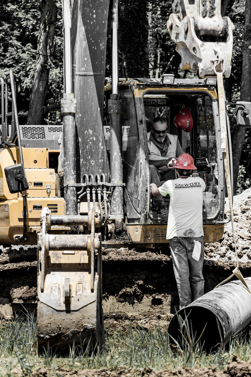 Two people talking in construction equipment